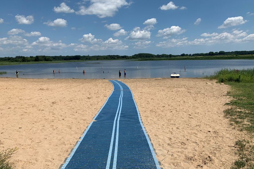 Beach mat stretching across beach to water's edge at Bong State Recreation Area