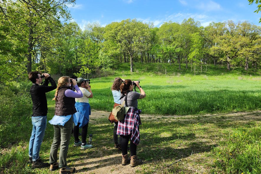 Participants of the 2024 Great Wisconsin Birdathon looking through binoculars while birding