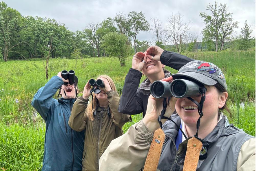 2024 Great Wisconsin Birdathon participants looking through binoculars