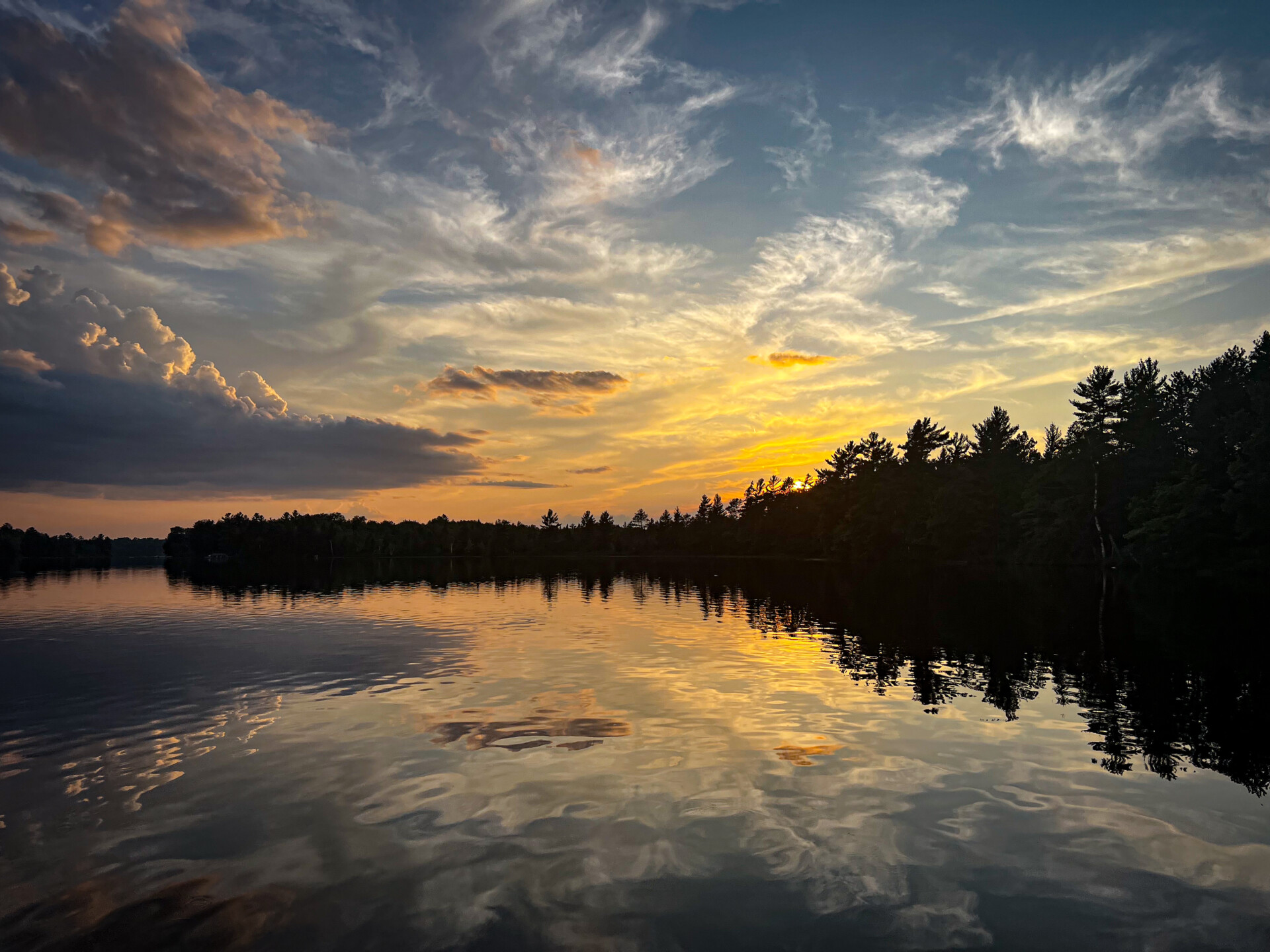 Sunset over a lake, with the sunset's reflection on the water