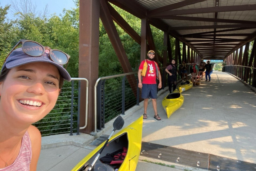 Angelica and a group of people lined up with kayaks. 