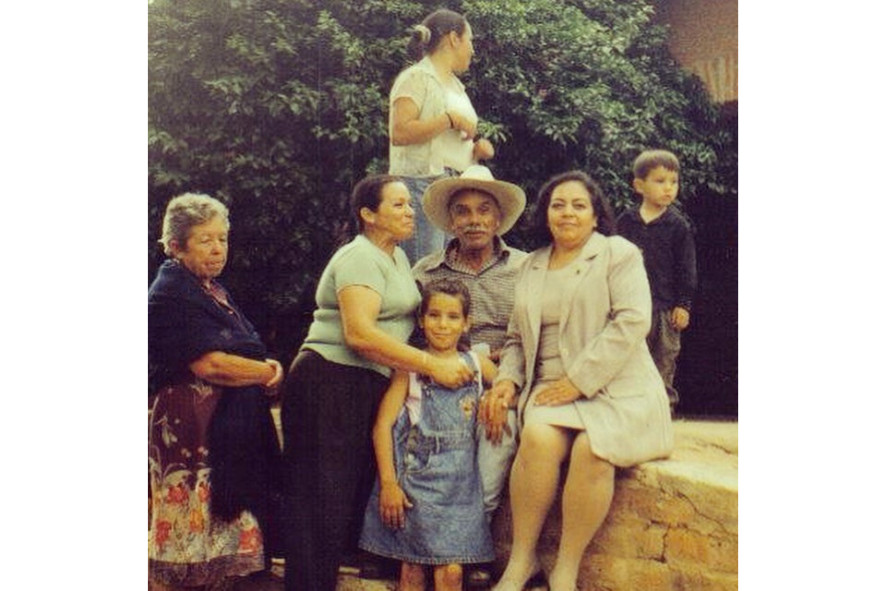 An old photo of Angelica as a child with family members 