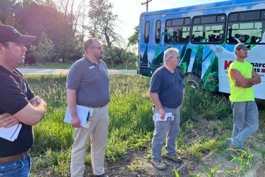 Ricardo (far left) talking with farmers. 