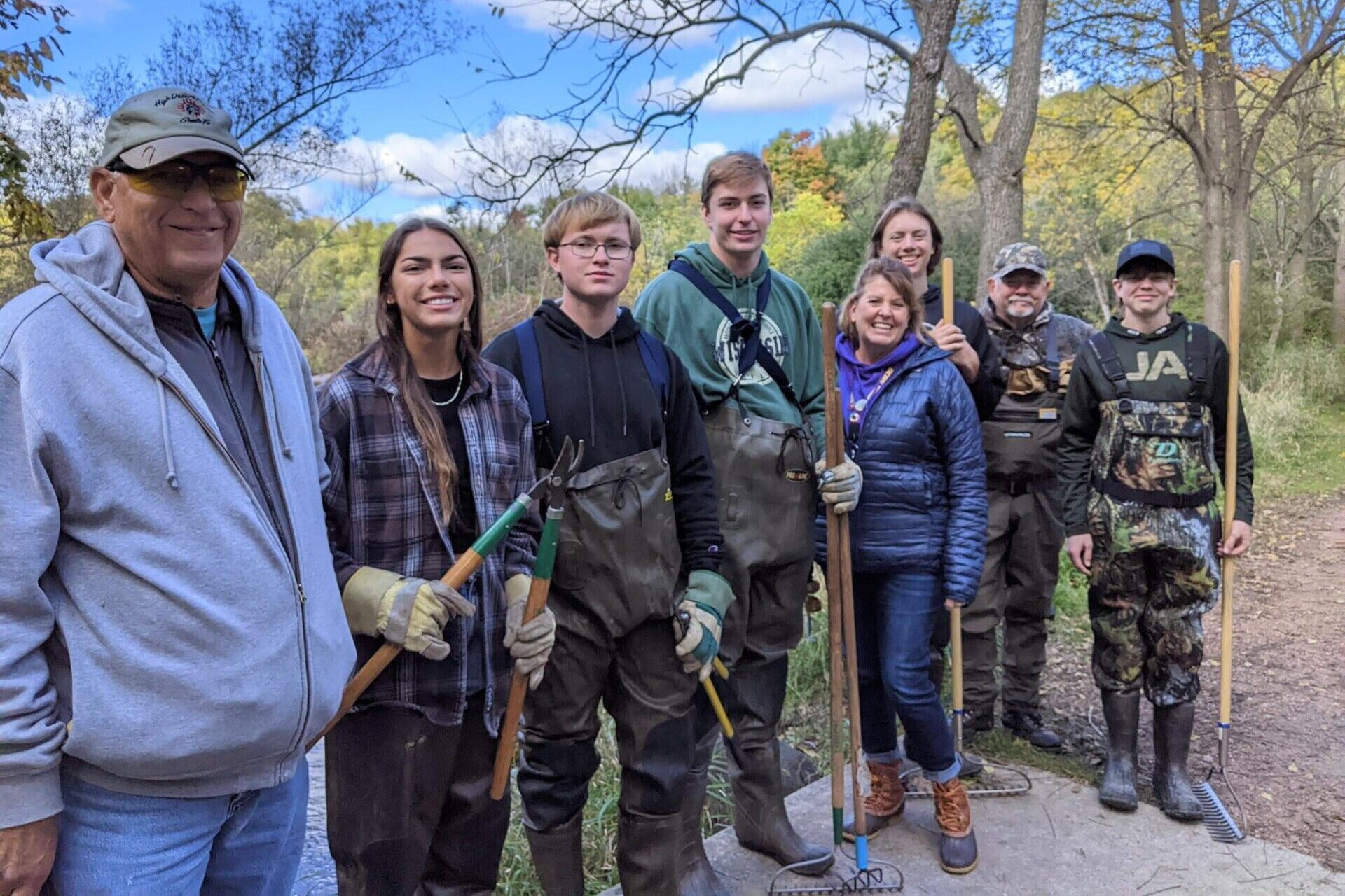 group of students and teachers outside in waders