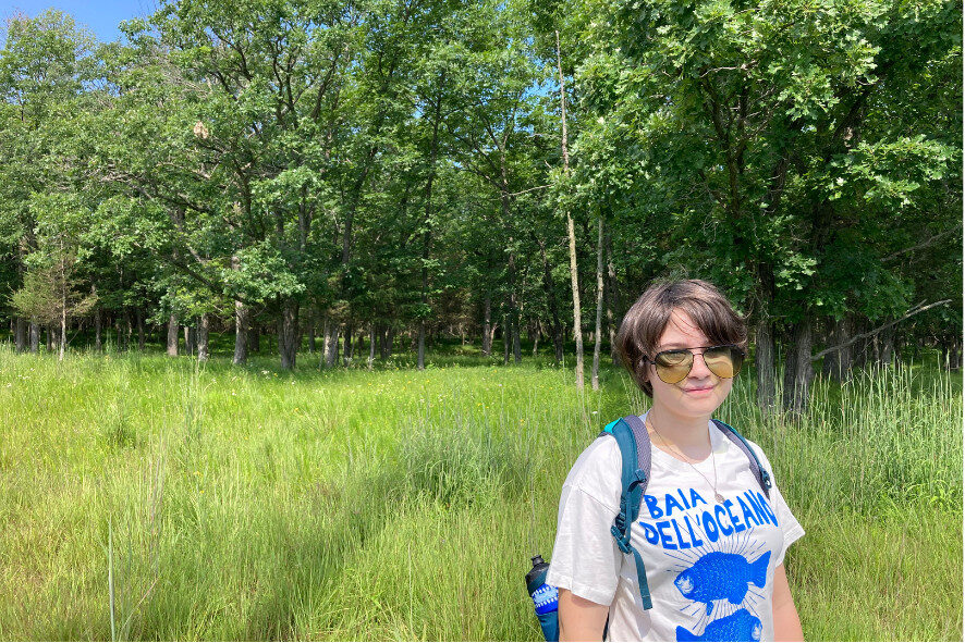 Madeline standing in a grassy field